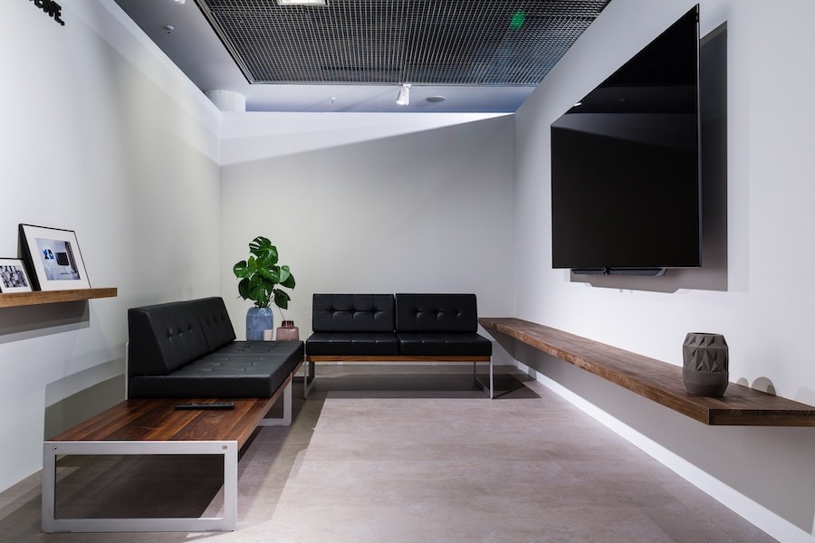 Basic living room setup with minimal decor and a flat-screen TV mounted on the wall.