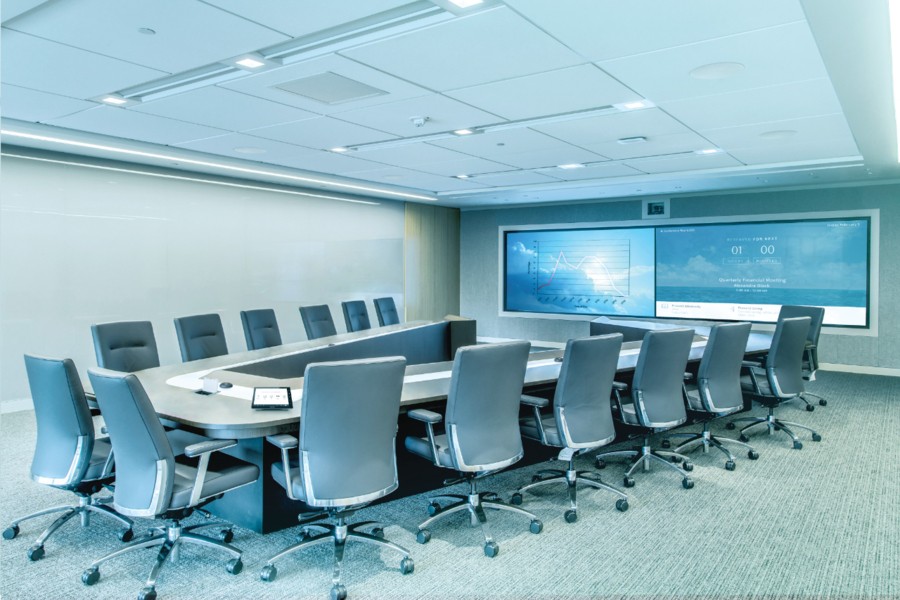 A large conference room in Santa Rosa designed with a U-shaped table, dual large displays, and integrated audio system. 