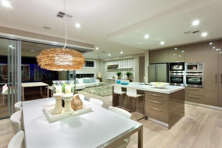 A kitchen and dining room setup with recessed lights.